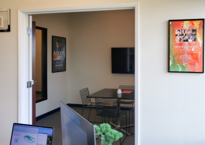 Two room office looking from desk into meeting area in second room