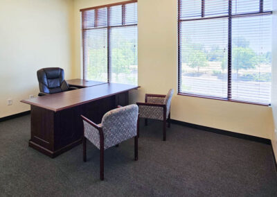 Office with large windows, L shaped executive desk and two guest chairs at Gateway Executive Suites Lincoln CA